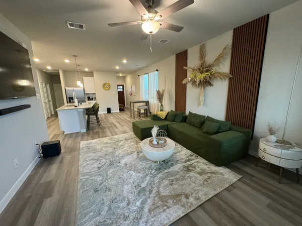 a living room with furniture and a chandelier