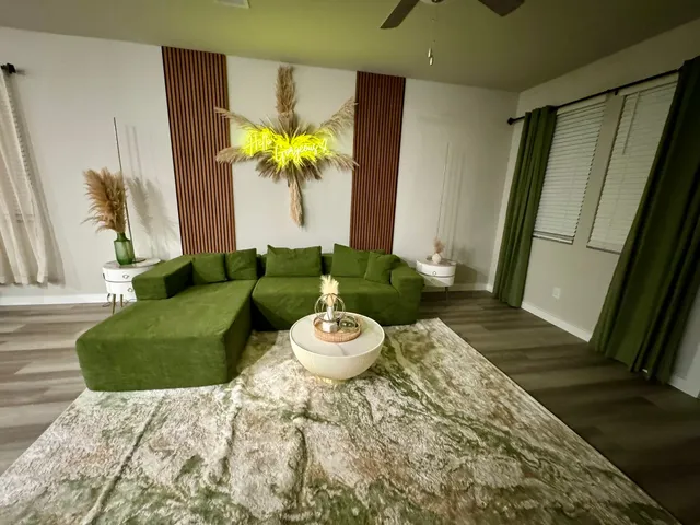 a living room with furniture and a chandelier