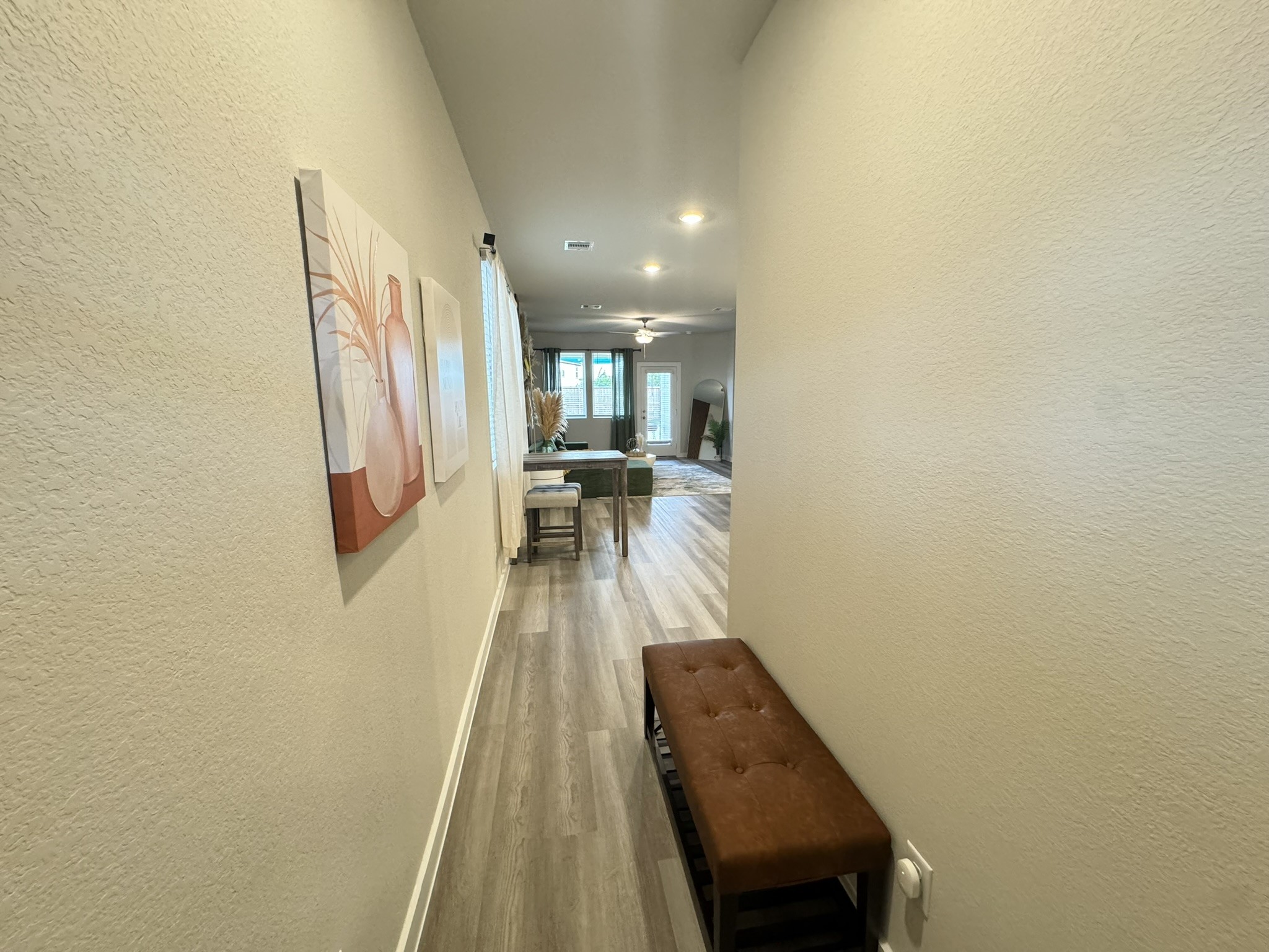 5608 Madden Lane Houston, TX 77048 - Photo 4 of 29 a hallway with a wooden floor and a potted plant