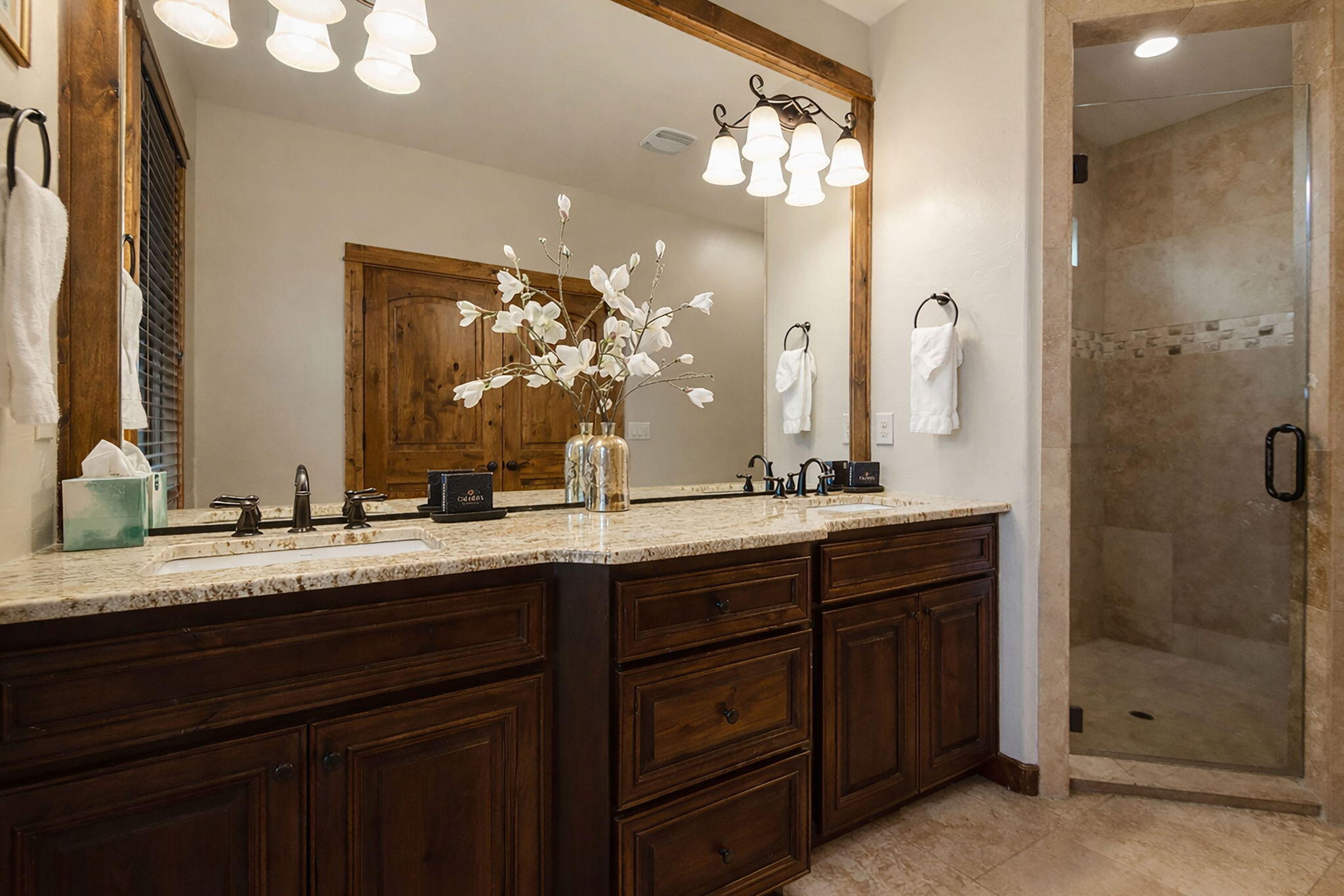 56508 Dancing Rock Loop, Unit 22 Bend, OR 97707 - Photo 34 of 69 a bathroom with a granite countertop sink and a mirror