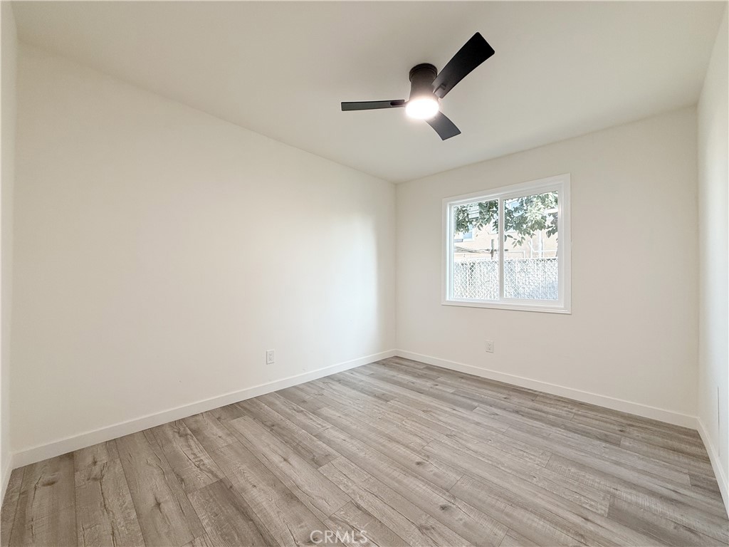 521 West Cherry Street Compton, CA 90222 - Photo 13 of 20 an empty room with wooden floor fan and windows