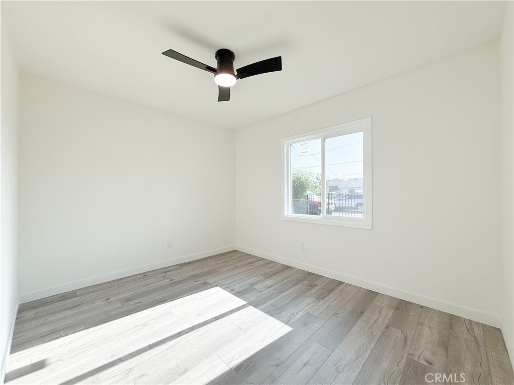 521 West Cherry Street Compton, CA 90222 - Photo 14 of 20 an empty room with wooden floor and windows