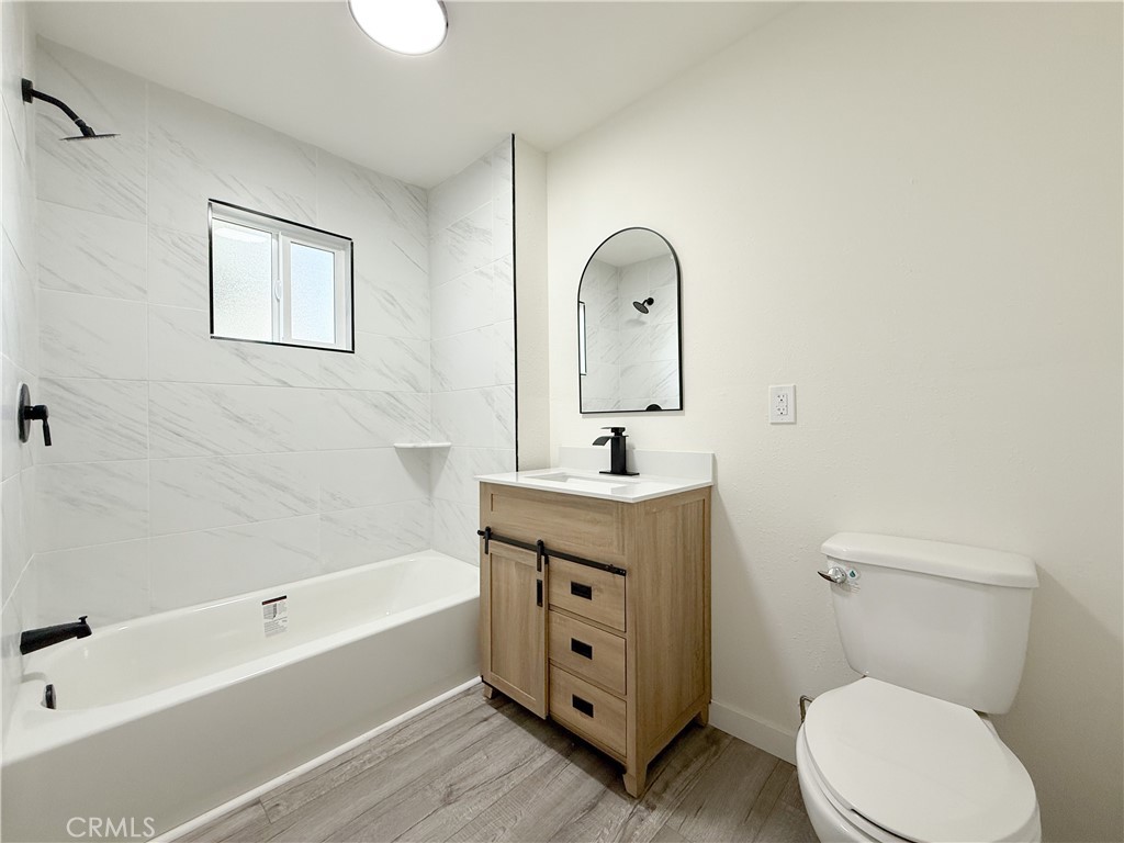 521 West Cherry Street Compton, CA 90222 - Photo 15 of 20 a bath room with a toilet a sink and a bathtub