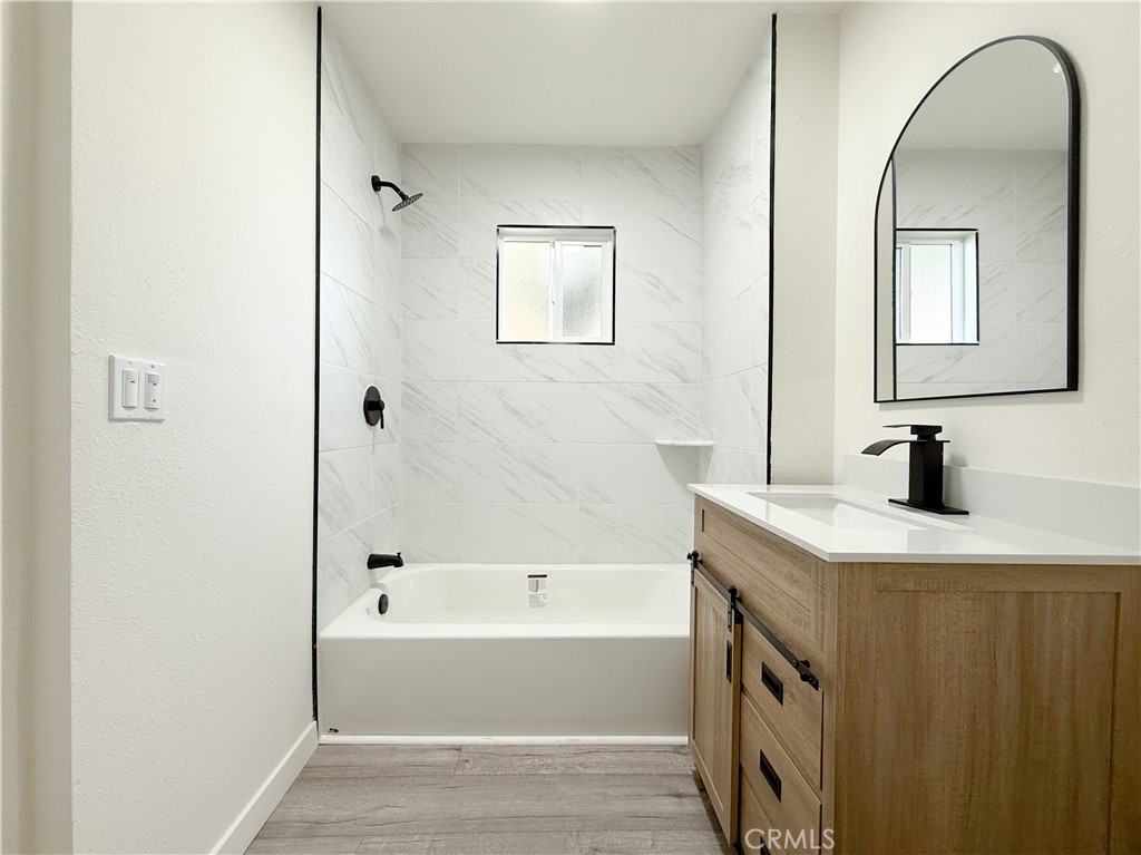 521 West Cherry Street Compton, CA 90222 - Photo 16 of 20 a bathroom with a granite countertop sink and a bathtub