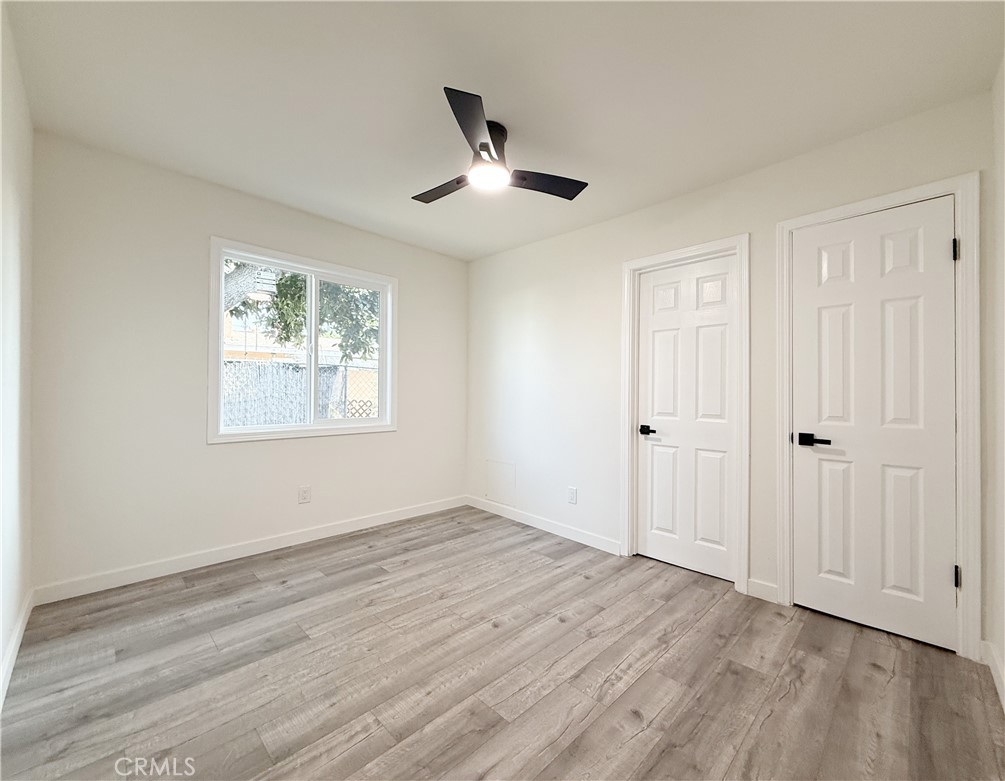 521 West Cherry Street Compton, CA 90222 - Photo 17 of 20 a view of an empty room with wooden floor and a window