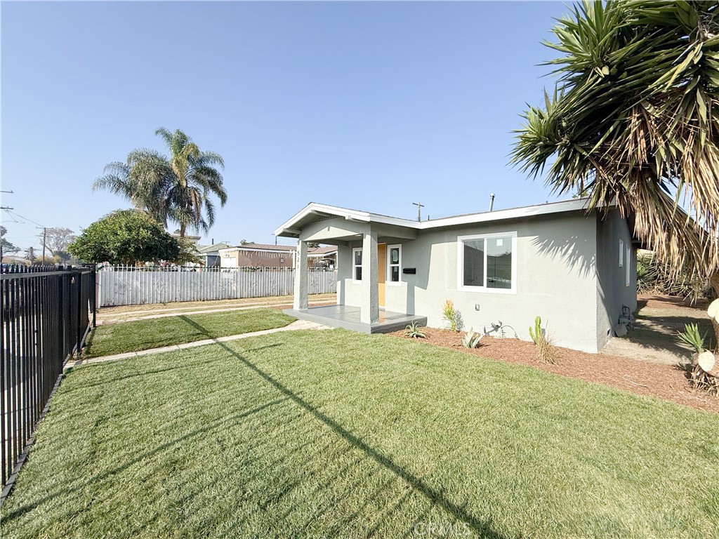 521 West Cherry Street Compton, CA 90222 - Photo 3 of 20 a house with palm tree in front of it