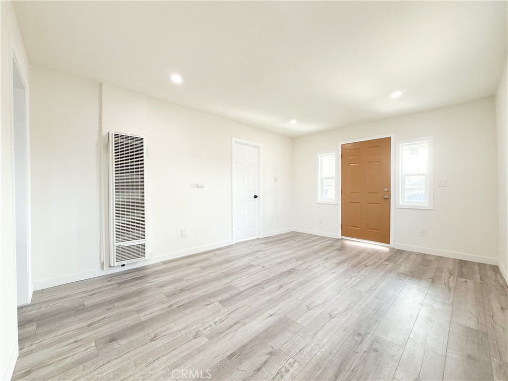 521 West Cherry Street Compton, CA 90222 - Photo 4 of 20 a view of an empty room with wooden floor and closet