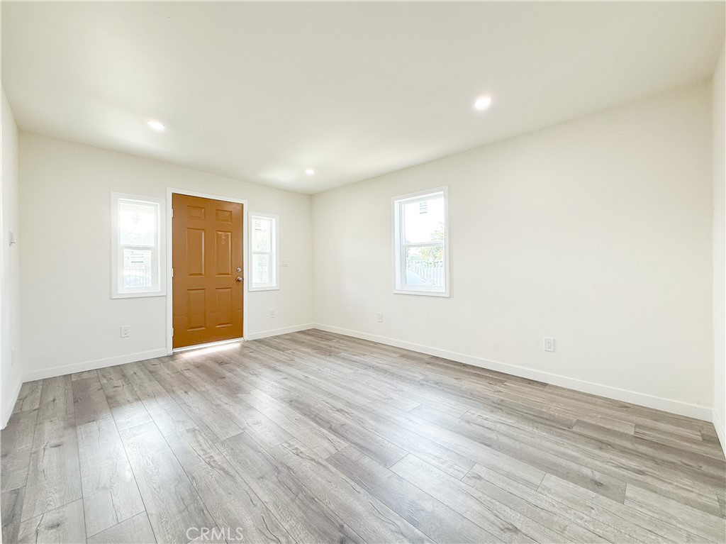 521 West Cherry Street Compton, CA 90222 - Photo 5 of 20 an empty room with wooden floor and windows