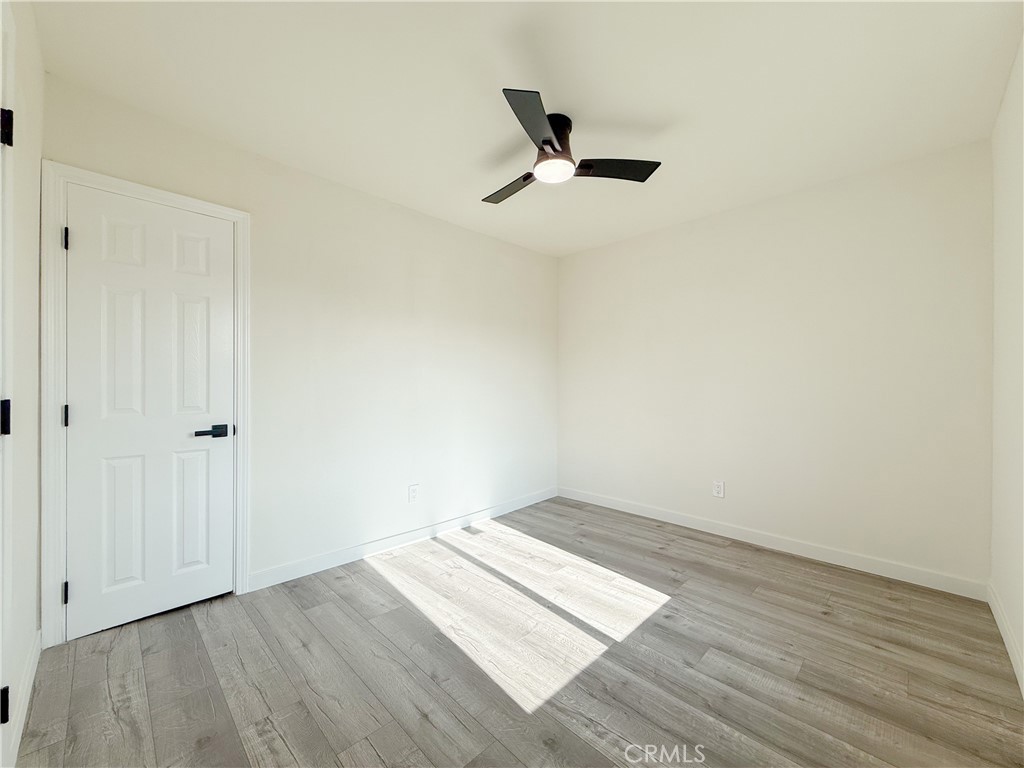 521 West Cherry Street Compton, CA 90222 - Photo 8 of 20 a view of a room with wooden floor and white walls