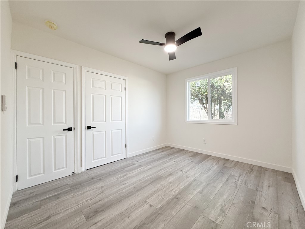521 West Cherry Street Compton, CA 90222 - Photo 9 of 20 a view of an empty room with wooden floor and a window