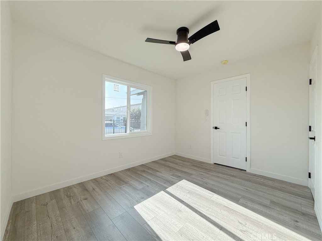 521 West Cherry Street Compton, CA 90222 - Photo 10 of 20 an empty room with wooden floor cabinet and windows