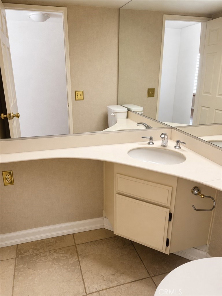 117 East Yale Loop, Unit 24 Irvine, CA 92604 - Photo 11 of 13 a bathroom with a sink and a mirror