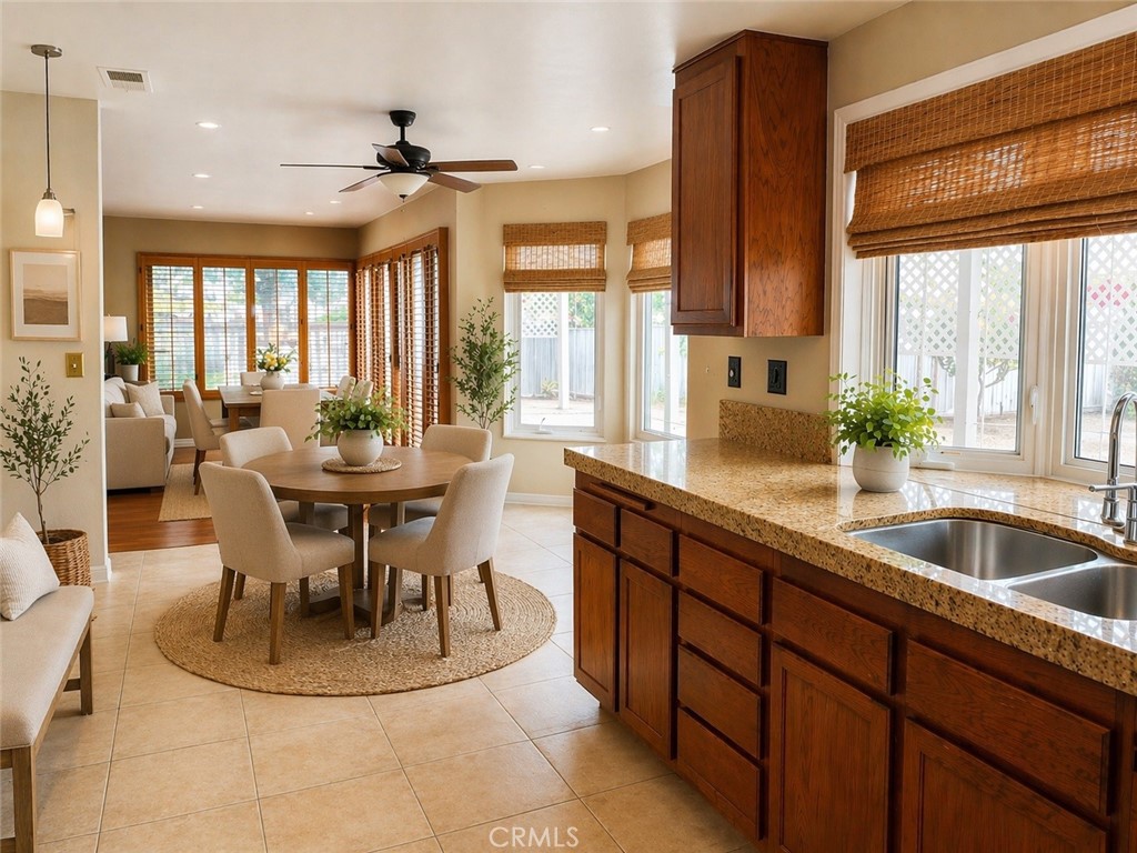 117 East Yale Loop, Unit 24 Irvine, CA 92604 - Photo 4 of 13 a kitchen with a dining table chairs and large window