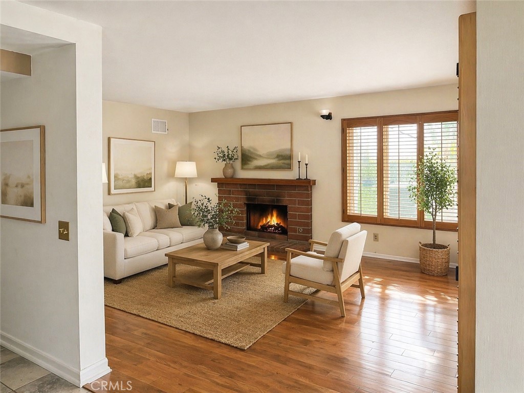 117 East Yale Loop, Unit 24 Irvine, CA 92604 - Photo 5 of 13 a living room with furniture and a fireplace