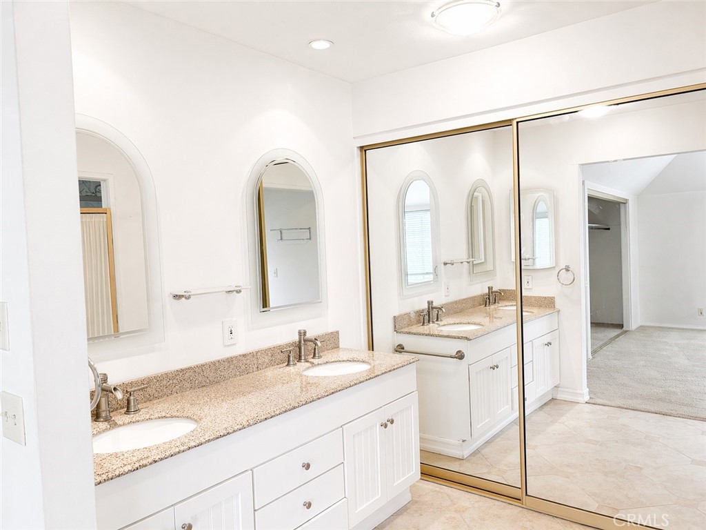 117 East Yale Loop, Unit 24 Irvine, CA 92604 - Photo 9 of 13 a bathroom with a double vanity sink mirror and double