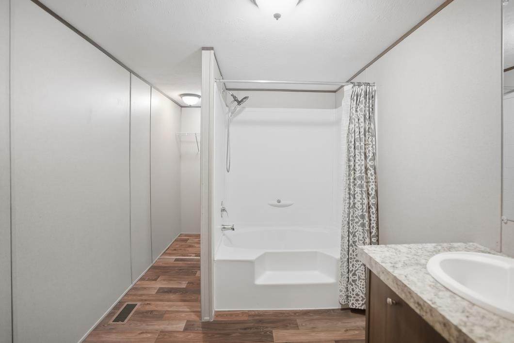 553 Jennifer Loop Orange Grove, TX 78372 - Photo 14 of 30 a bathroom with a granite countertop sink and shower