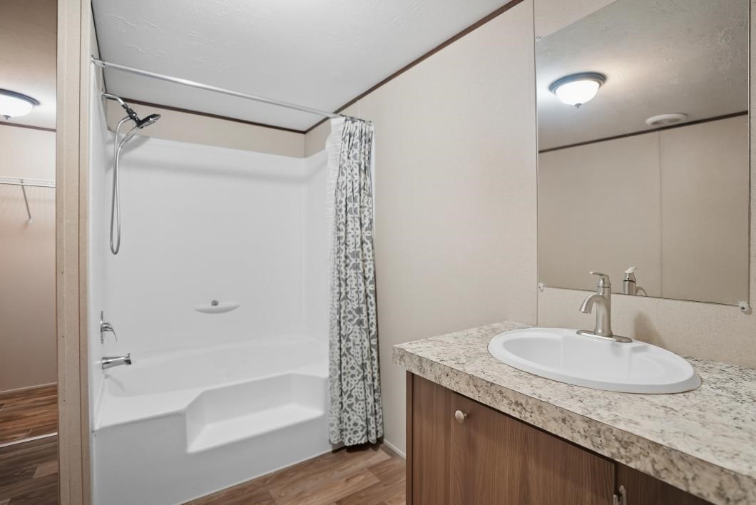 553 Jennifer Loop Orange Grove, TX 78372 - Photo 15 of 30 a bathroom with a granite countertop sink and a mirror