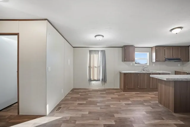 a view of a kitchen with a sink and a refrigerator
