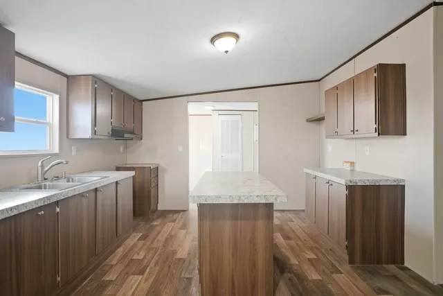 a kitchen with granite countertop cabinets stainless steel appliances a sink and a counter top space