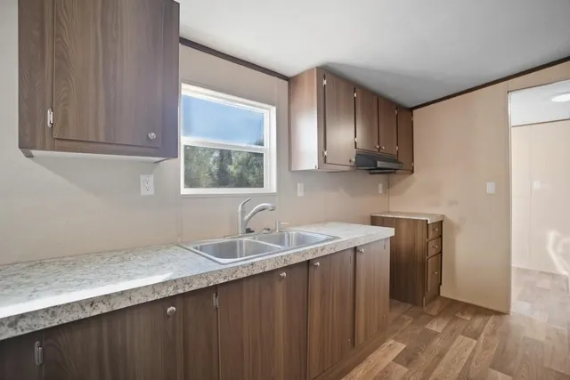 a kitchen with a sink and cabinets