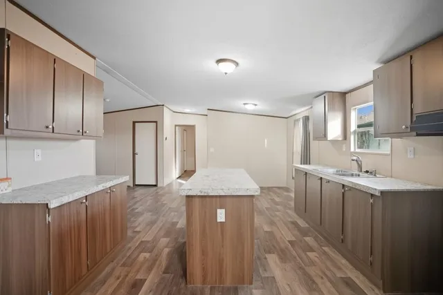 a kitchen with a sink window and cabinets