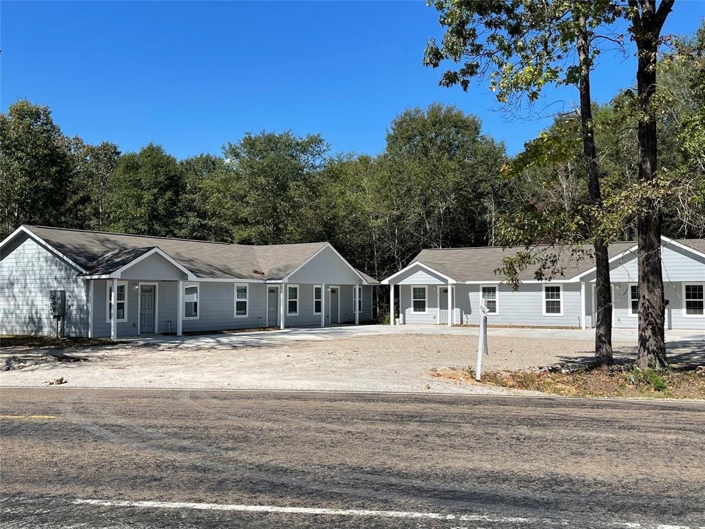 635 Martin Luther King Road Ames, TX 77575 - Photo 1 of 20 a front view of a house with a garden