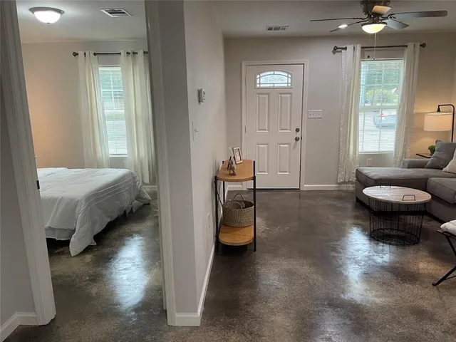 a bedroom with bed and window