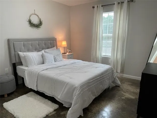 a bedroom with a bed and a window