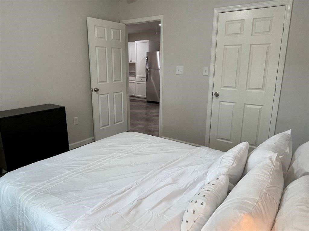 635 Martin Luther King Road Ames, TX 77575 - Photo 17 of 20 a bedroom with a bed and wooden floor
