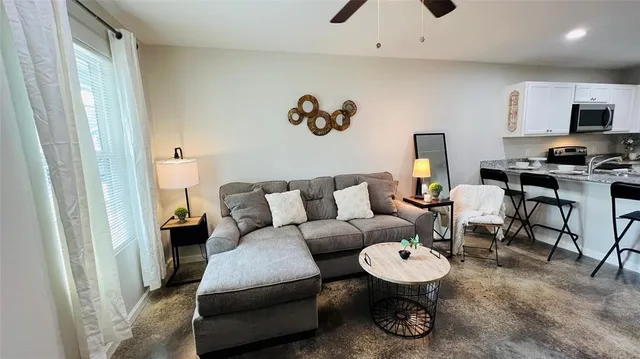 a living room with furniture and a mirror