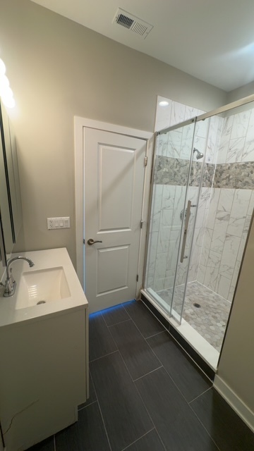 22 North Parkside Avenue, Unit 1 Chicago, IL 60644 - Photo 12 of 13 a bathroom with a sink and a mirror
