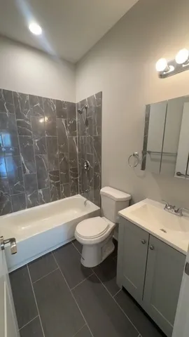 a bathroom with a sink a toilet and bathtub