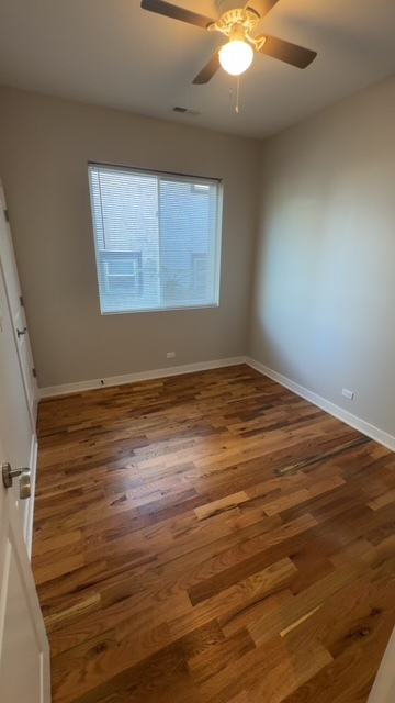 22 North Parkside Avenue, Unit 1 Chicago, IL 60644 - Photo 8 of 13 an empty room with wooden floor and windows