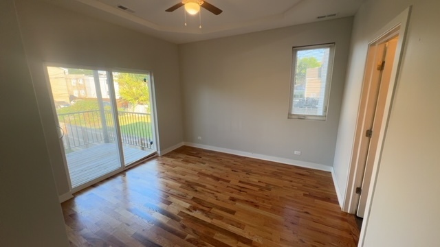 22 North Parkside Avenue, Unit 1 Chicago, IL 60644 - Photo 9 of 13 a view of an empty room with wooden floor and a window