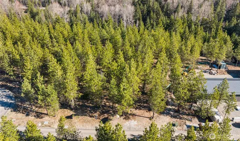 an aerial view of a residential houses with yard