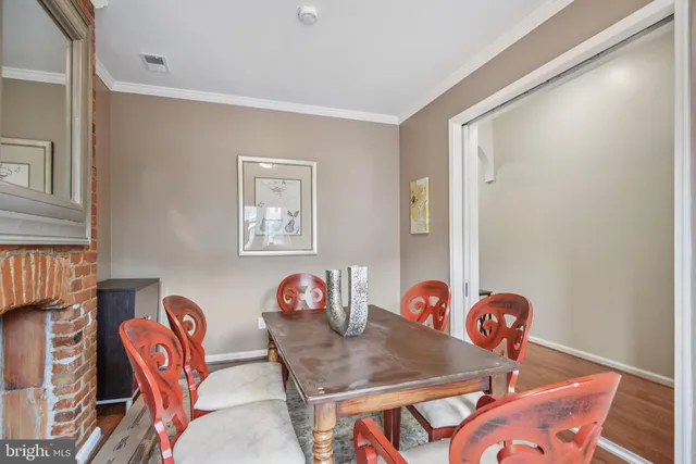 a dining room with furniture and wooden floor