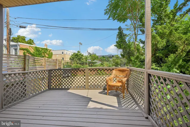 a view of balcony with wooden floor and bench