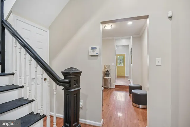 a view of a hallway with wooden floor and staircase