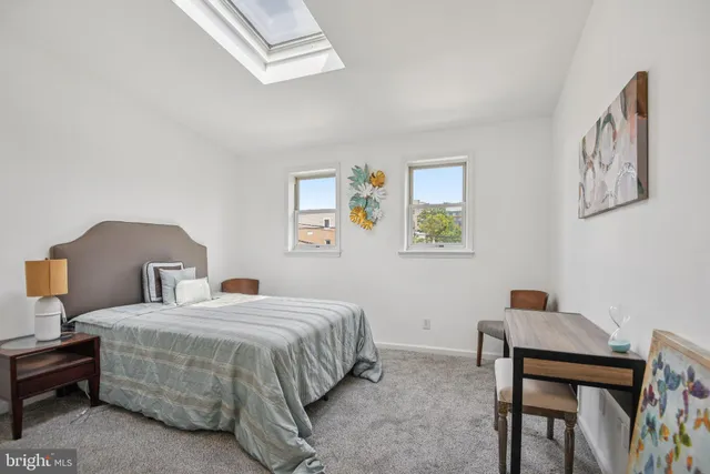 a bedroom with a bed and a desk