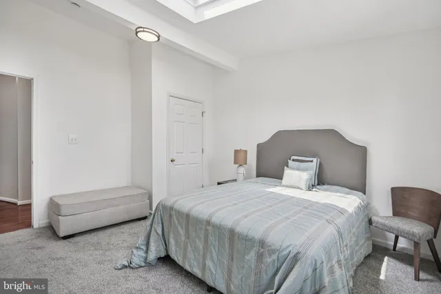 a bedroom with a bed and a chair