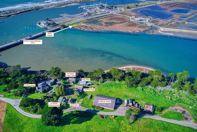 an aerial view of a house with a garden and lake view