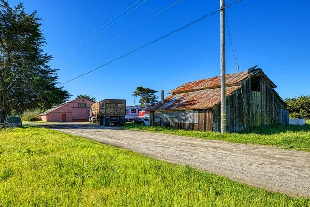 a front view of house with yard and car parked