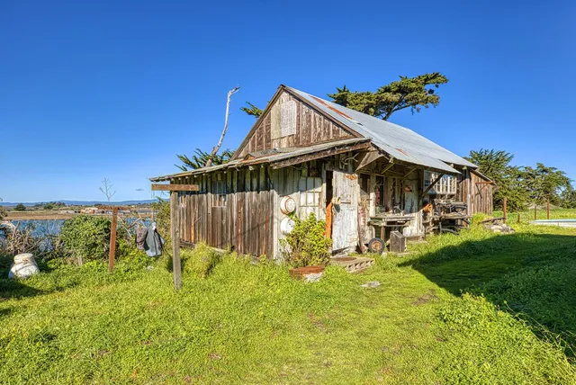 a view of a house with backyard and patio
