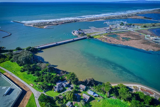 an aerial view of a house with a garden and lake view