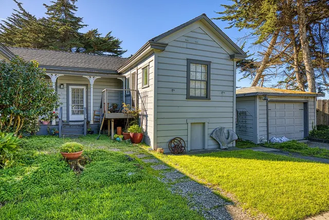 a view of a house with a yard and sitting area