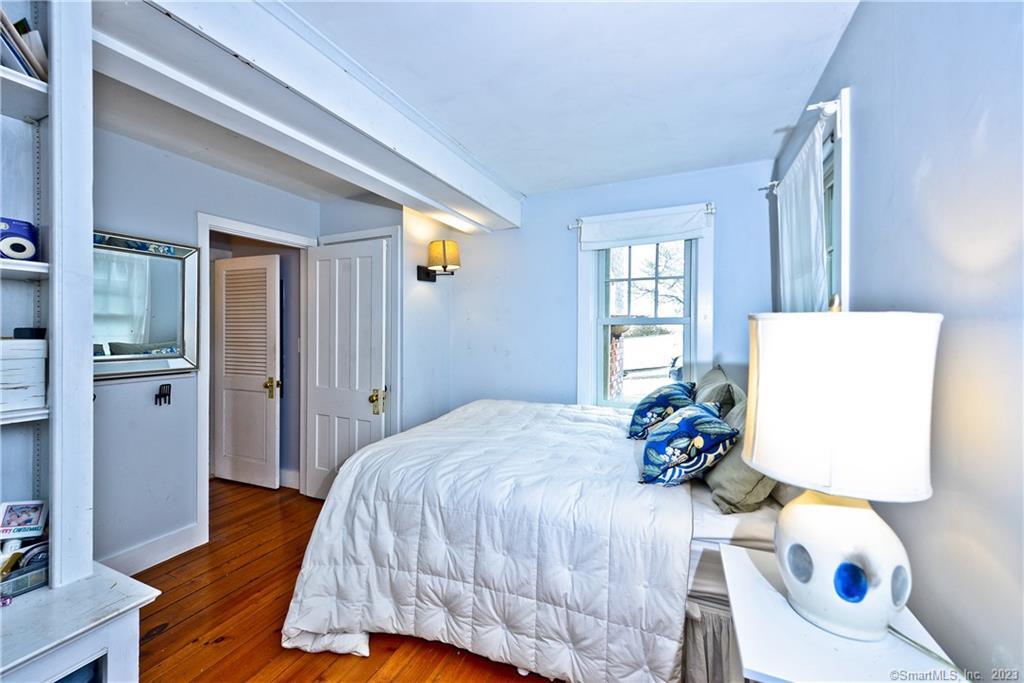 20 Omega Street Stonington, CT 06378 - Photo 12 of 37 a bedroom with a bed and wooden floor