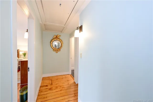 a kitchen with cabinets stainless steel appliances and wooden floor