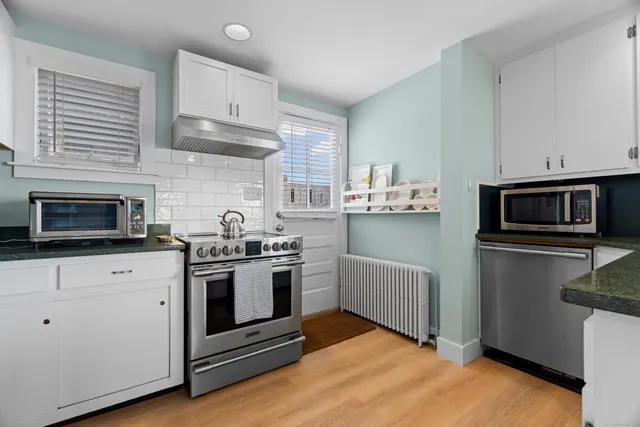 a kitchen with a sink stove and cabinets