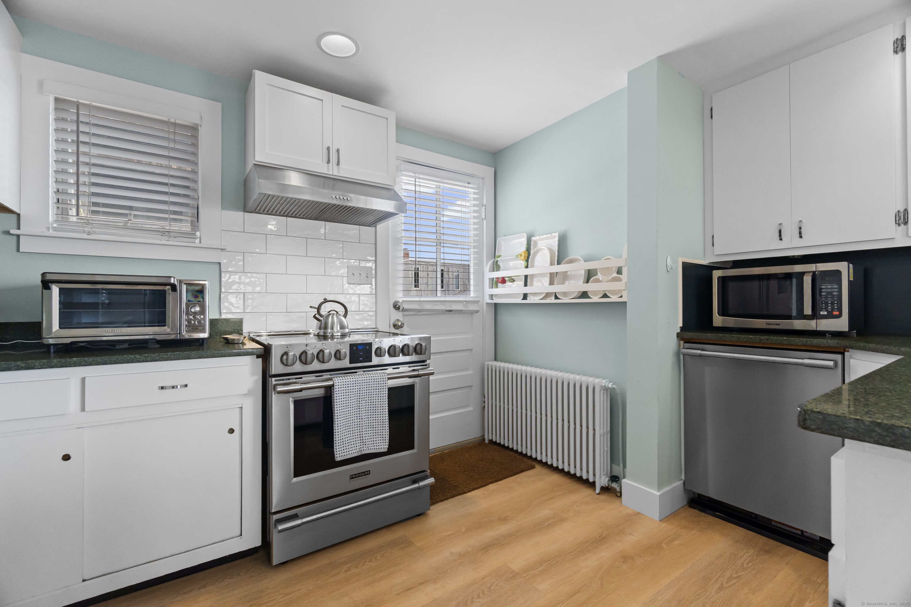 20 Omega Street Stonington, CT 06378 - Photo 16 of 37 a kitchen with cabinets stainless steel appliances and wooden floor