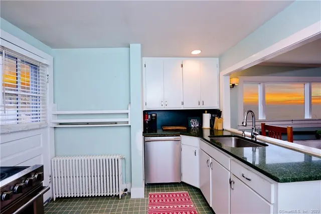 a kitchen with sink refrigerator and cabinets